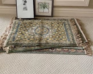 Several small prayer rugs in blues, beiges and gold