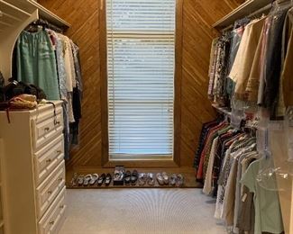 Two closets filled with men’s and women’s clothes and shoes.