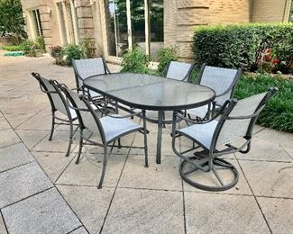 $525 - Glass table top dining table and six chairs. Two end chairs rock and swivel. Table measures,  28"H x 74"L x 42"W. Chairs measures,  35"H x 22.5"W x 28"D. Height to seat is approx. 18.5"H. 