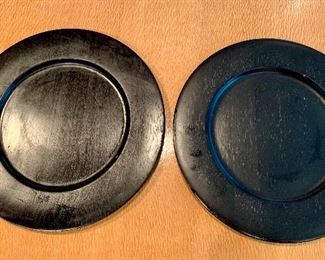 $60 - Set of 12 black wood chargers; 14" diameter. Wear consistent with use and age. 