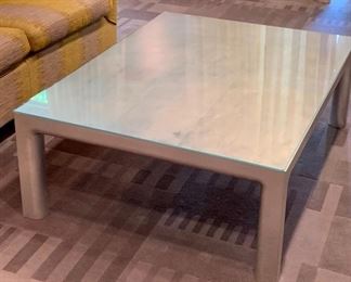 $495 FIRM -  Silver leaf parsons style decorator coffee table with glass top; 16"H x 48"L x 36"W
