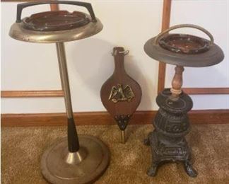 This time capsule of a lot features an art deco brass ash tray stand with handle. It also includes an amber glass ash tray. It measures approximately 26 inches in height. This lot also includes a vintage pot belly stove ash tray smoking stand. This unique ash tray stands about 21 inches high and the base measures about 7.5 inches square. There is also a vintage fireplace hand operated air blower. Our client said this was a gift to her in the 1980's. There was a Made In Taiwan sticker so it may only be an estimated 40 years old. https://ctbids.com/#!/description/share/932851