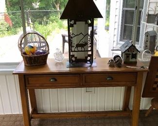 Two-drawer table; vintage fishing reels; cool metal lamp with elk-and-forest design.