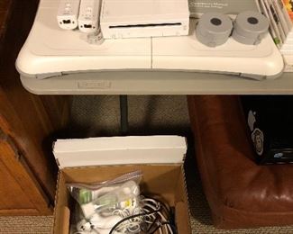 Nintendo Wii console with games and accessories.
