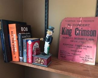 Antique replica Uncle Sam mechanical bank; King Crimson concert flier/poster.