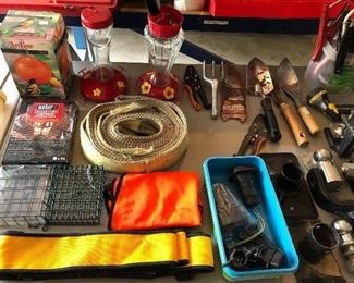 Numerous tools and yard and garden accessories in the garage.