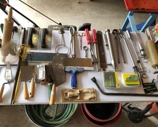 Numerous tools and yard and garden accessories in the garage.