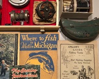 Vintage fishing reels, tackle, and books.