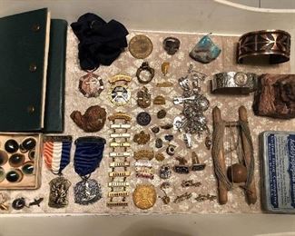 Numerous smalls including men’s jewelry, vintage National Rifle Association medals, and various curiosities.