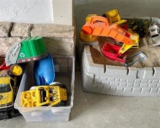 Item 192:  Lot of Toy Trucks (left):  $16                                                                   Item 193:  Sandbox with Toys (right):  $32