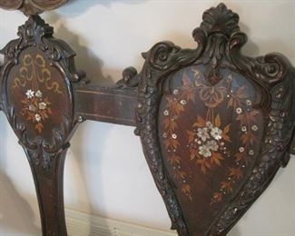 A carved and inlaid Loveseat.