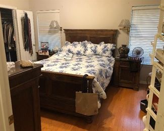 One of the packed bedrooms, this one filled with a Queen Bed, nightstands, a large dresser/mirror by Bassett. Also, high-quality shoes, like Ecco, and professional clothing. 
