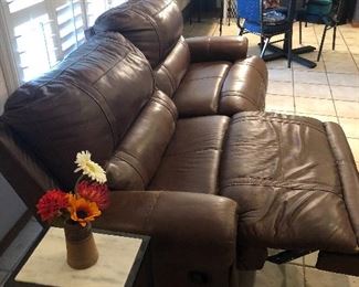 Double-reclining brown leather couch. Very soft with no tears or other signs of wear. 