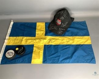 Autographed Sweden Flag, Hat and Pucks
