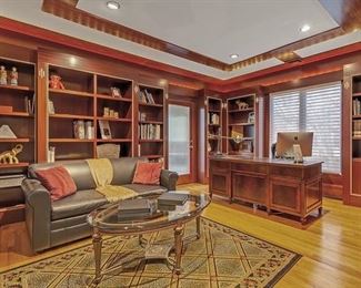 Leather sleep sofa, glass top coffee table, geometric rug, desk not for sale