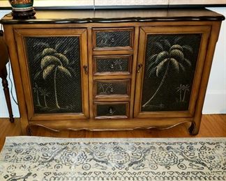 Two door/four drawer well made cabinet has hand painted palm trees & biscuit jar