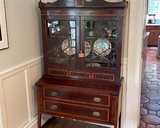 ANTIQUE SECRETARY BOOKCASE | Having glazed cabinet doors with geometric patterns (glass separated by muntins), over a fold-down writing surface over two full-width drawers; h. 76 x 42 x 19 in. 