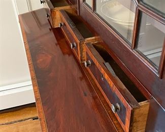 ANTIQUE SECRETARY BOOKCASE | Having glazed cabinet doors with geometric patterns (glass separated by muntins), over a fold-down writing surface over two full-width drawers; h. 76 x 42 x 19 in. 