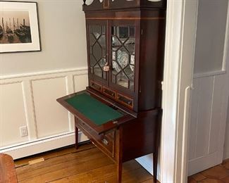 ANTIQUE SECRETARY BOOKCASE | Having glazed cabinet doors with geometric patterns (glass separated by muntins), over a fold-down writing surface over two full-width drawers; h. 76 x 42 x 19 in. 