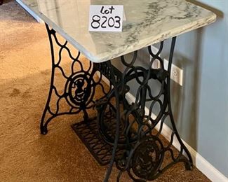 Lot 8203. $225.00 Wrought Iron "Singer" Treadle base with marble top. Super Cute Table. 31.5" W x 17" L x 28.5" T