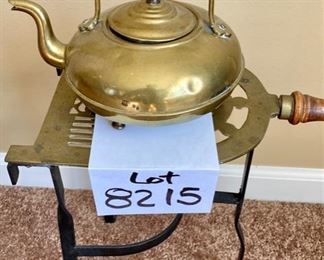 Lot 8215. $75.00. Three Piece Wood Handled brass warming stand (7" W x 14" T x 13" L) with a footed brass tea pot (JCB marking) with amber glass handle (10"w x 7"diam x 8" T) and a smaller amber glass handled footed tea pot (JCB marking). Very Rare Set.