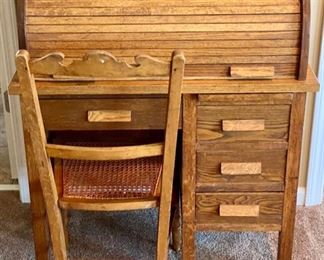 Lot 8217 $125.00 Vintage Oak Roll Top Child's Desk with matching caned seat desk chair. Great accent or functional piece. (32"w x 18"d x 38.5"l)