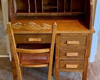 Lot 8217 $125.00 Vintage Oak Roll Top Child's Desk with matching caned seat desk chair. Great accent or functional piece. (32"w x 18"d x 38.5"l)