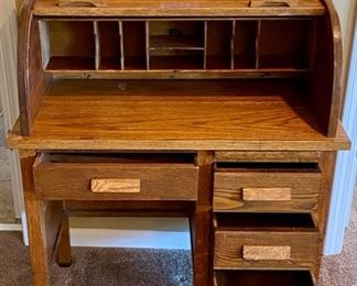 Lot 8217 $125.00 Vintage Oak Roll Top Child's Desk with matching caned seat desk chair. Great accent or functional piece. (32"w x 18"d x 38.5"l)