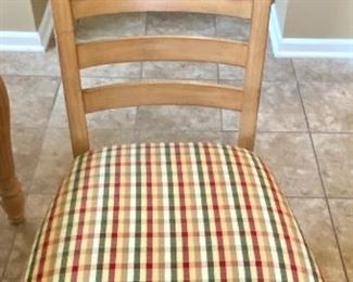 Lot 8261. $350.00. Knotty Pine Solid Wood Kitchen Table. It's a great workhorse of a table and includes 1 leaf and 6 chairs (one chair needs the seat pad to be resecured to the base). Light colored wood with column-ish style legs, the chair seats are a nice plaid with red, gold, cream seat pads. Normal usage wear. 61"l x 42"w x 31"t, 1 18" leaf, 6 chairs: 21"w x 27" d x 41"t to back