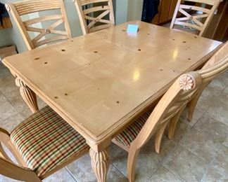 Lot 8261. $350.00. Knotty Pine Solid Wood Kitchen Table. It's a great workhorse of a table and includes 1 leaf and 6 chairs (one chair needs the seat pad to be resecured to the base). Light colored wood with column-ish style legs, the chair seats are a nice plaid with red, gold, cream seat pads. Normal usage wear. 61"l x 42"w x 31"t, 1 18" leaf, 6 chairs: 21"w x 27" d x 41"t to back