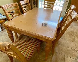 Lot 8261. $350.00. Knotty Pine Solid Wood Kitchen Table. It's a great workhorse of a table and includes 1 leaf and 6 chairs (one chair needs the seat pad to be resecured to the base). Light colored wood with column-ish style legs, the chair seats are a nice plaid with red, gold, cream seat pads. Normal usage wear. 61"l x 42"w x 31"t, 1 18" leaf, 6 chairs: 21"w x 27" d x 41"t to back