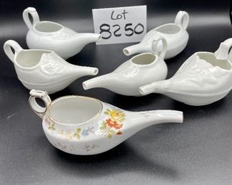 Lot 8250. $50.00 Lot of 6 elongated porcelain, infant/hospital/invalid feeders. 1) Gold trim, floral design, 2) Scalloped edge with cool details, signed "H", 3) White, unsigned, 4) #2830, white, 5) 2985, white , repair on handle,6) #8250 white w/leaf on top.