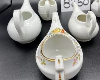 Lot 8250. $50.00 Lot of 6 elongated porcelain, infant/hospital/invalid feeders. 1) Gold trim, floral design, 2) Scalloped edge with cool details, signed "H", 3) White, unsigned, 4) #2830, white, 5) 2985, white , repair on handle,6) #8250 white w/leaf on top.