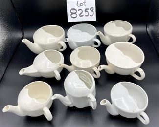 Lot 8253. $60.00 Lot of 9 white and cream colored self-feeders.