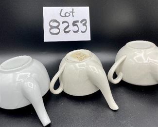Lot 8253. $60.00 Lot of 9 white and cream colored self-feeders.