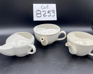 Lot 8253. $60.00 Lot of 9 white and cream colored self-feeders.
