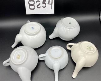 Lot 8254. $60.00 Lot of 8 side-handled infant/hospital/invalid feeders plus a cute duck shaped feeder that has a standard handle placement. 1) Gray, elephant snout feeder, 2) White duck with standard handle, 3) White, mini- side handle feeder, 4) cream colored - Royal Winton 'Made in England, 5) White, marked with an S under a crown made in Denmark, 6) white with a mark and #721, 7) marked #200 Schmid.