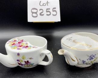 Lot 8255. $70.00. Lot of 7 side- handled infant/hospital/invalid feeders. All have a design and/or are colored in some way. 1) signed Vienna, Austria Edelweiss floral design,"Fur Genesung", which translates to "for recovery", 2) Cobalt blue color with floral images, 3) Purple violets, Vienna, Austria, 4) Pink rosebud design made in Victoria, Austria, 5) White with blue flower from London Covent Garden, 6) Lily of the Vally, marked #357, and 7) blue floral design embellishes the entire feeder cup.