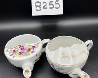 Lot 8255. $70.00. Lot of 7 side- handled infant/hospital/invalid feeders. All have a design and/or are colored in some way. 1) signed Vienna, Austria Edelweiss floral design,"Fur Genesung", which translates to "for recovery", 2) Cobalt blue color with floral images, 3) Purple violets, Vienna, Austria, 4) Pink rosebud design made in Victoria, Austria, 5) White with blue flower from London Covent Garden, 6) Lily of the Vally, marked #357, and 7) blue floral design embellishes the entire feeder cup.