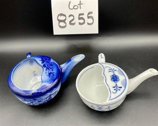 Lot 8255. $70.00. Lot of 7 side- handled infant/hospital/invalid feeders. All have a design and/or are colored in some way. 1) signed Vienna, Austria Edelweiss floral design,"Fur Genesung", which translates to "for recovery", 2) Cobalt blue color with floral images, 3) Purple violets, Vienna, Austria, 4) Pink rosebud design made in Victoria, Austria, 5) White with blue flower from London Covent Garden, 6) Lily of the Vally, marked #357, and 7) blue floral design embellishes the entire feeder cup.
