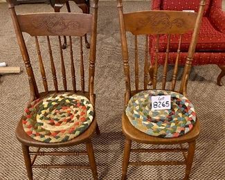 Lot 8265. $38.00 Pair of antique or vintage wooden chairs with carved spindle backs and two rag rug cushions. 16" W x 19" D x 37" T