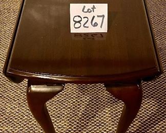 Lot. 8267. $125.00 Vintage side dark stained end table, with drop leaves that form a circular table when sides are up, features Queen Anne legs. Excellent Condition 16" W x 28" D x 24" T (open 32" W)