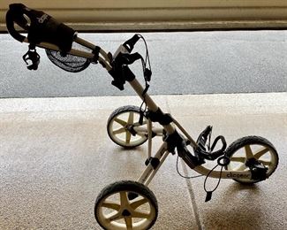Lot 8273. $180.00. Clicgear Model 3.5+ bag pull cart, easily folds up to fit in your trunk. New these carts cost $500+. If Tesla made a Golf Cart this would be the one.