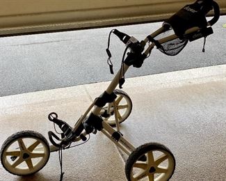Lot 8273. $180.00. Clicgear Model 3.5+ bag pull cart, easily folds up to fit in your trunk. New these carts cost $500+. If Tesla made a Golf Cart this would be the one.