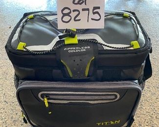 Lot 8275. $35.00. Titan Deep Freeze Zipperless Coldlok "Radiant Barrier Technology" Portable Cooler...very nice! This item has a plastic tray that sits above the bottom to keep your food dry.