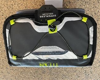 Lot 8275. $35.00. Titan Deep Freeze Zipperless Coldlok "Radiant Barrier Technology" Portable Cooler...very nice! This item has a plastic tray that sits above the bottom to keep your food dry.