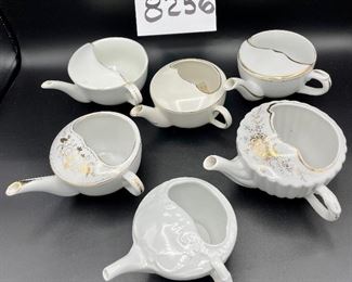Lot 8256. $50.00 Lot of 6 side-handled infant/hospital/invalid feeders primarily in white. 1) white & gold with a "Z" mark, 2) Chantilly white pattern, 3) Ribbed gold,4) white with gold 'Empireware England", 5) white with gold trim "MAW", 6) white body with gold trim that has rubbed away places.
