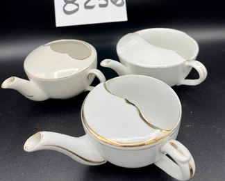 ot 8256. $50.00 Lot of 6 side-handled infant/hospital/invalid feeders primarily in white. 1) white & gold with a "Z" mark, 2) Chantilly white pattern, 3) Ribbed gold,4) white with gold 'Empireware England", 5) white with gold trim "MAW", 6) white body with gold trim that has rubbed away places.