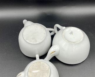 Lot 8257. $60.00. Lot of 6, side-handled infant/hospital/invalid feeders all with some design. 1) Red Cross, #4767 on bottom, 2) red, yellow & blue design and image of baby, 3) Red Cross/gold trim, marked "98" on bottom, 4) Pink & plum floral, marked "7317", 5) Purple floral with gold, 6) blue floral. Our favorite lot.