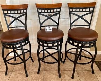 Lot 8286.$120.00 3 metal frame swivel bar stools from, 300 lb max.weight load, wood accent on back with faux brown leather seats. 45"t x 29" seat height x 18" dia